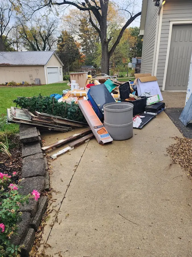 Dumpster being loaded with debris for Commercial Dumpster Rental in Marquette